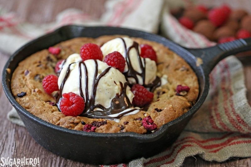 Raspberry Truffle Skillet Cookies - packed with gooey chocolate truffles, raspberries, and nuts! | From SugarHero.com