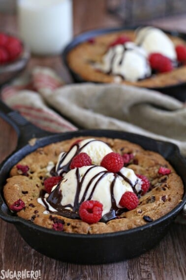 Close up of a Raspberry Truffle Skillet Cookie on a wooden table.