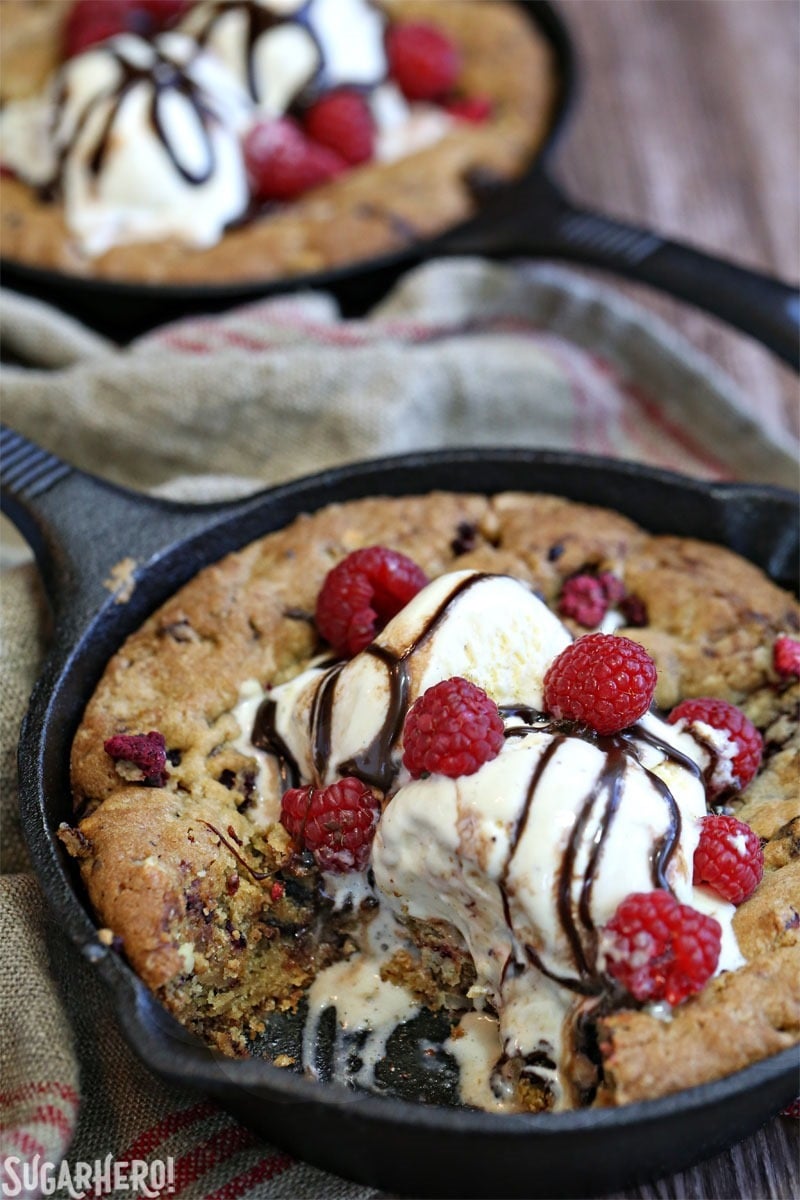 Raspberry Truffle Skillet Cookies - packed with gooey chocolate truffles, raspberries, and nuts! | From SugarHero.com
