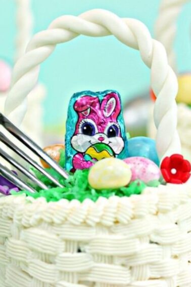 A fork going into an Easter basket cupcake with two other cupcakes in the background.