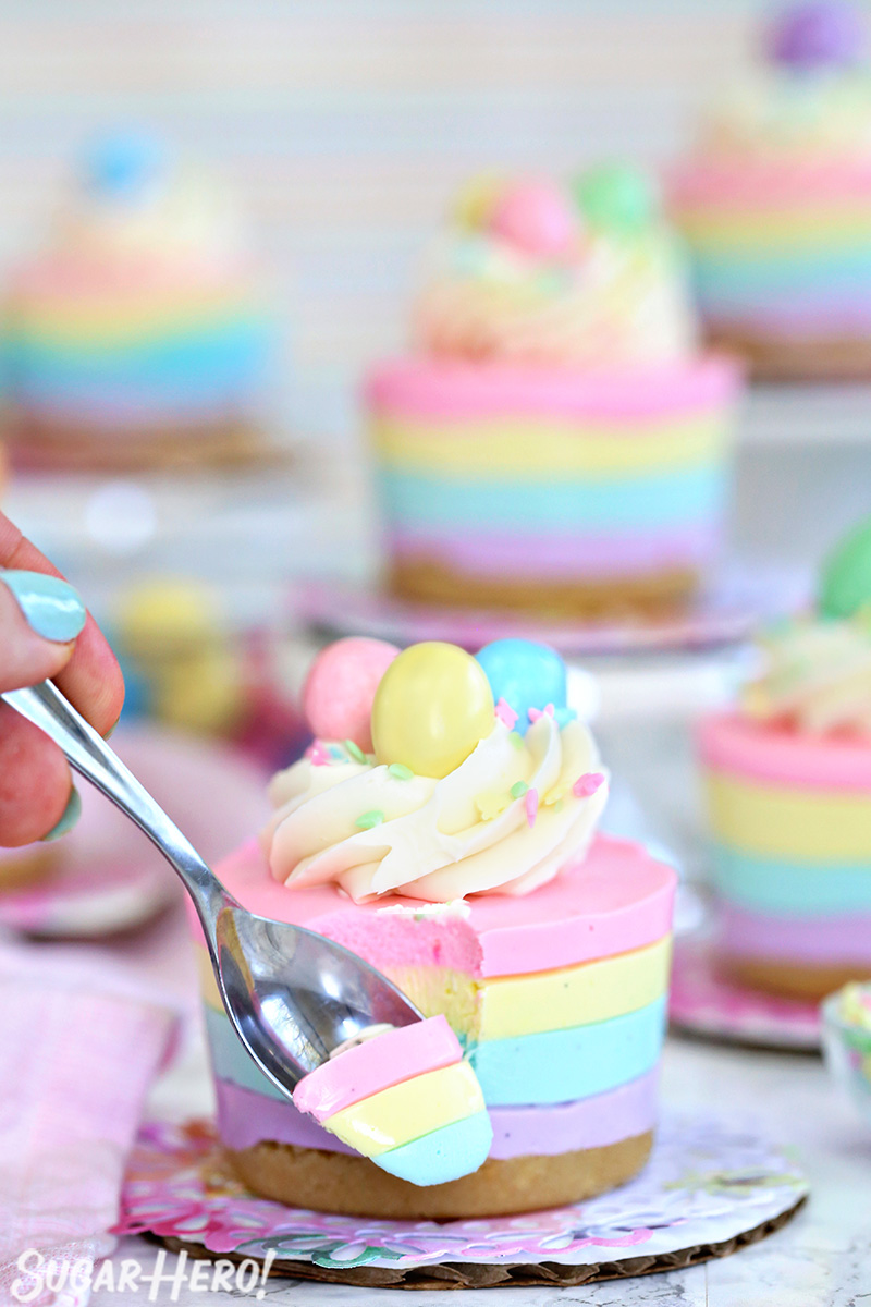 Easter no-bake mini cheesecake with a spoonful on a metal spoon in front of the cheesecake.