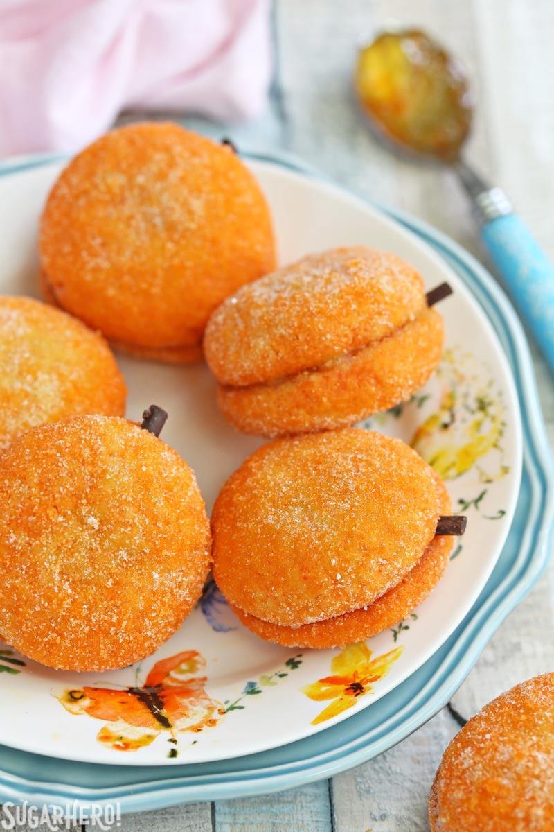 Clementine Cookies - A picture of the clementine cookies displayed on a plate. | From SugarHero.com Clementine Cookies - beautiful sandwich cookies that look AND taste like real clementines! | From SugarHero.com