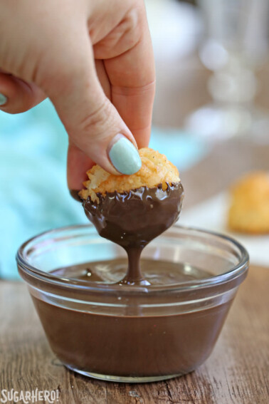 Coconut Macaroon dripping chocolate over a small glass bowl.