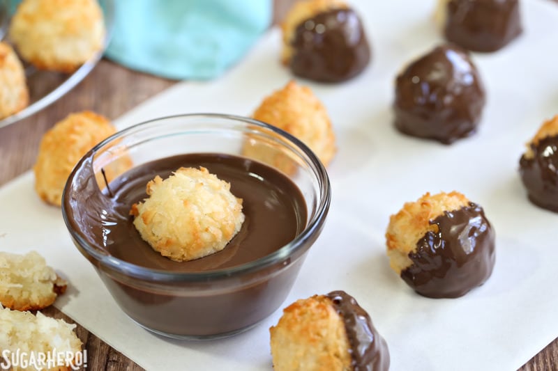 Coconut Macaroons - gluten-free coconut cookies dunked in rich semi-sweet chocolate. Crispy on the outside, soft and chewy on the inside. | From SugarHero.com