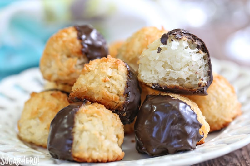 Coconut Macaroons - gluten-free coconut cookies made with just a handful of ingredients! Crispy on the outside, soft and chewy on the inside. | From SugarHero.com Coconut Macaroons - gluten-free coconut cookies half-dunked in semi-sweet chocolate. Crispy, chewy, and delicious! | From SugarHero.com