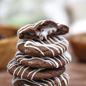 A stack of Junior Mint Cookies with the top cookie showing inside layer.