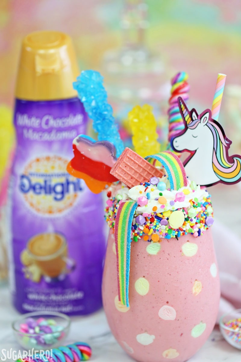 Unicorn Milkshakes - strawberry milkshakes topped with a magical assortment of rainbow candies and treats! | From SugarHero.com
