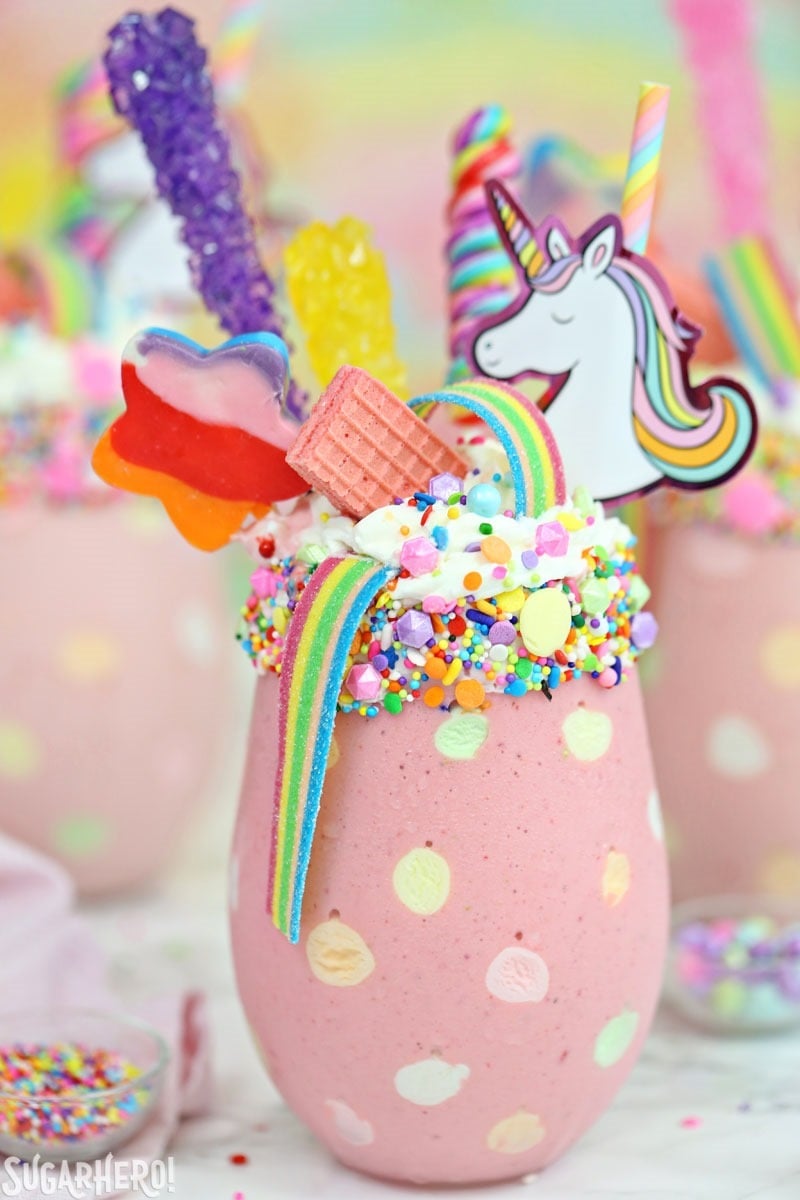 Unicorn Milkshakes - strawberry milkshakes topped with a magical assortment of rainbow candies and treats! | From SugarHero.com