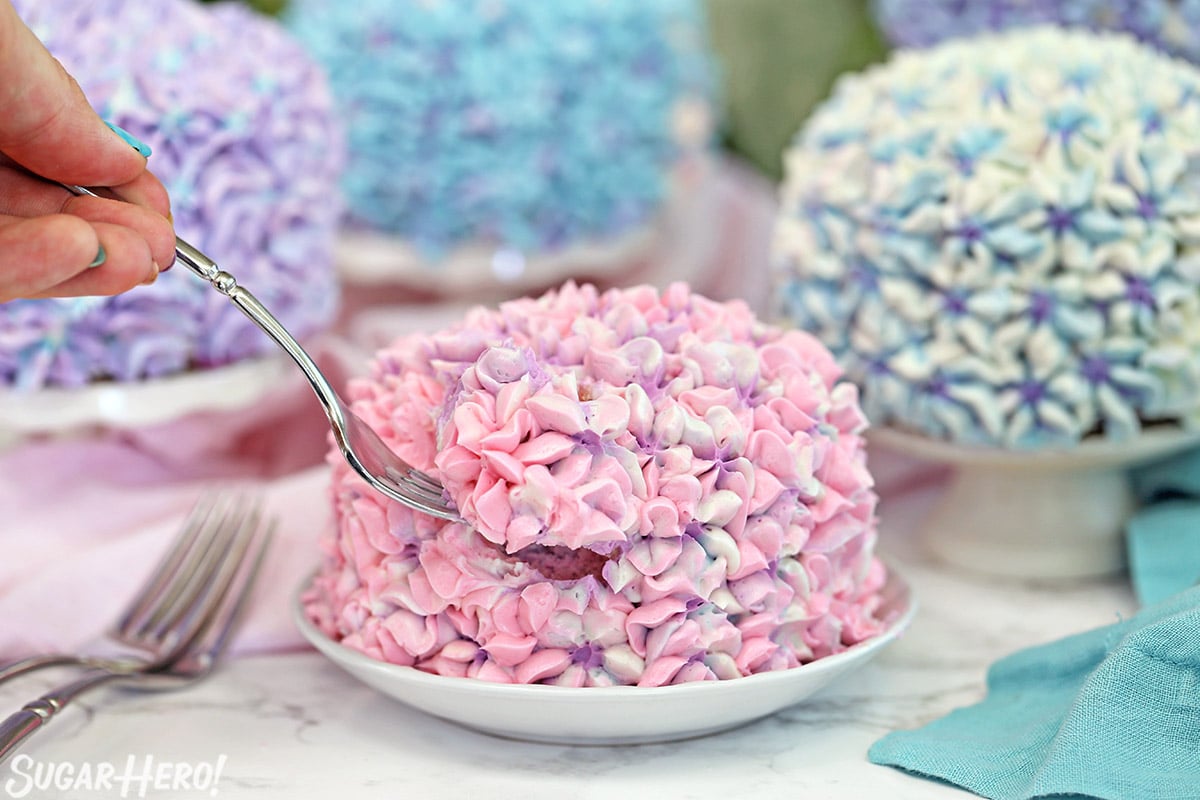 Four hydrangea cakes in various pastel colors.