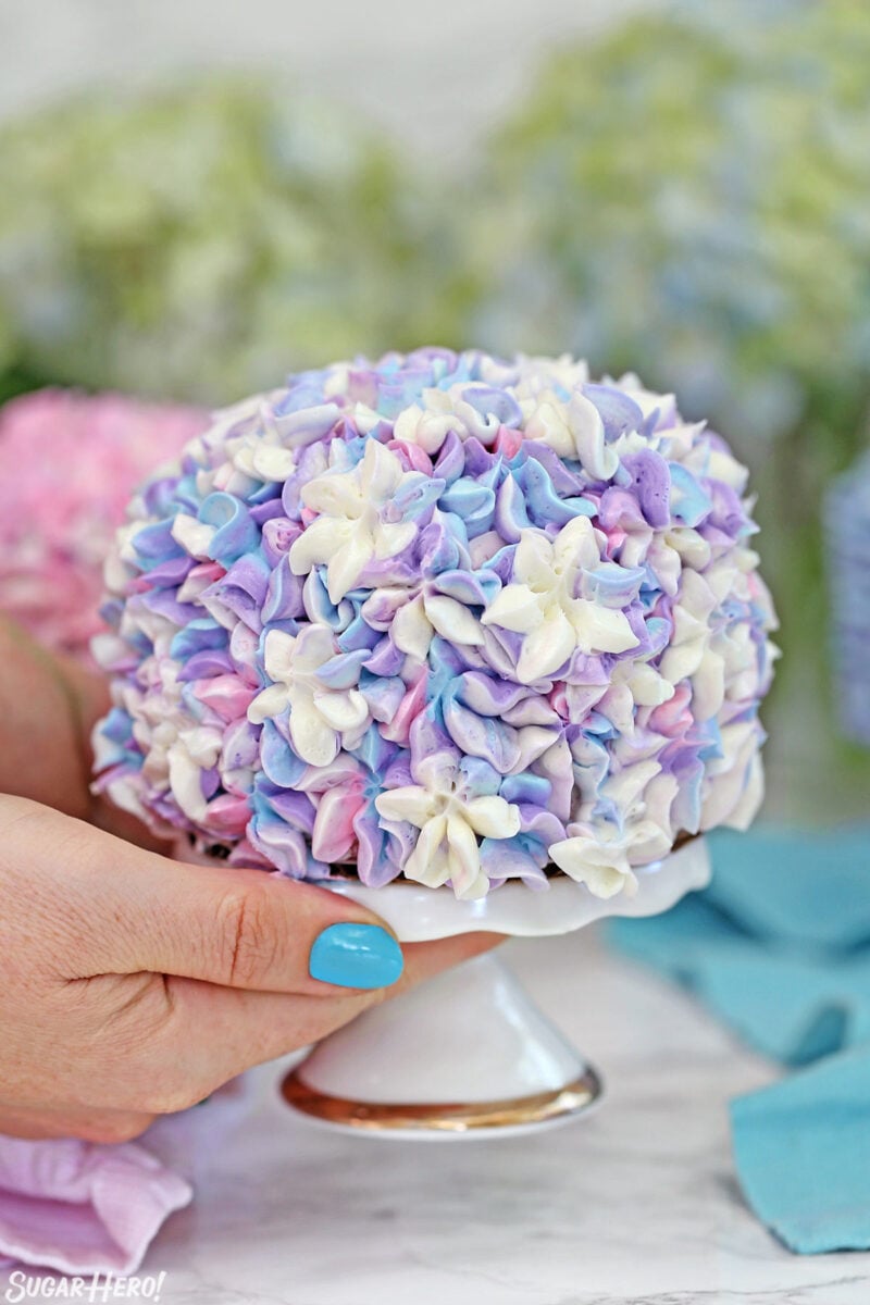 Close up of a purple, blue, and white hydrangea cake.