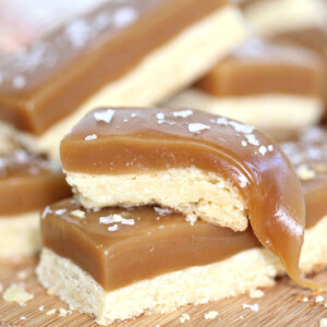2 Salted Caramel Bars stacked with caramel dripping off first bar.