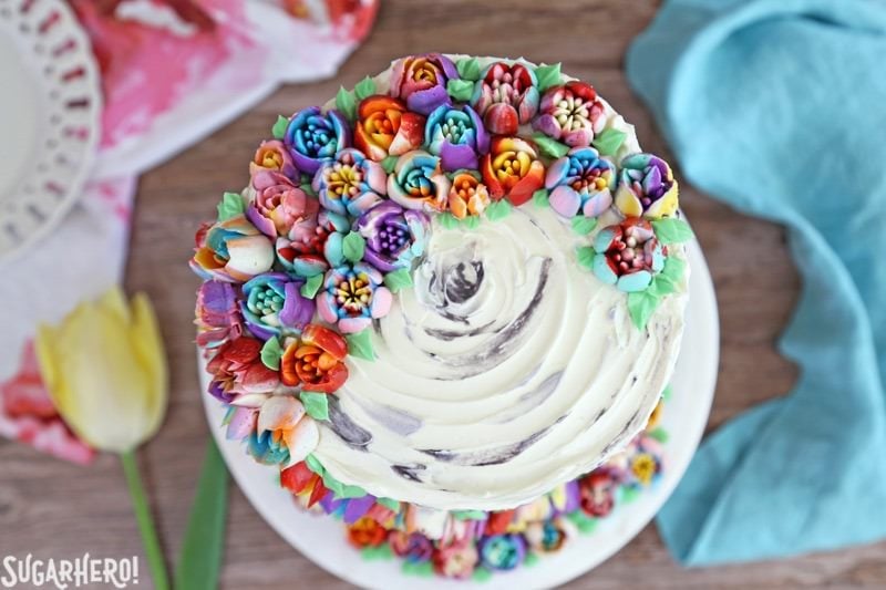 Spring In Bloom Layer Cake - an extra-tall cake COVERED in gorgeous buttercream flowers! | From SugarHero.com