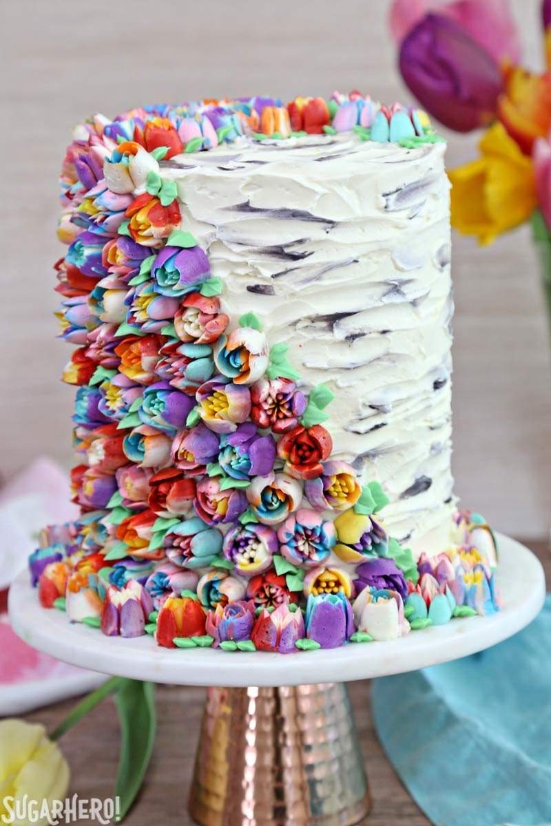 Spring In Bloom Layer Cake - an extra-tall cake COVERED in gorgeous buttercream flowers! | From SugarHero.com