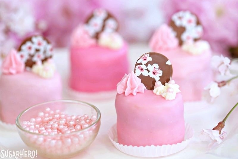 Cherry Blossom Petit Fours - cute little cake bites filled with cherry buttercream and jam! | From SugarHero.com Cherry Blossom Petit Fours - cute little cake bites filled with cherry buttercream and jam! | From SugarHero.com