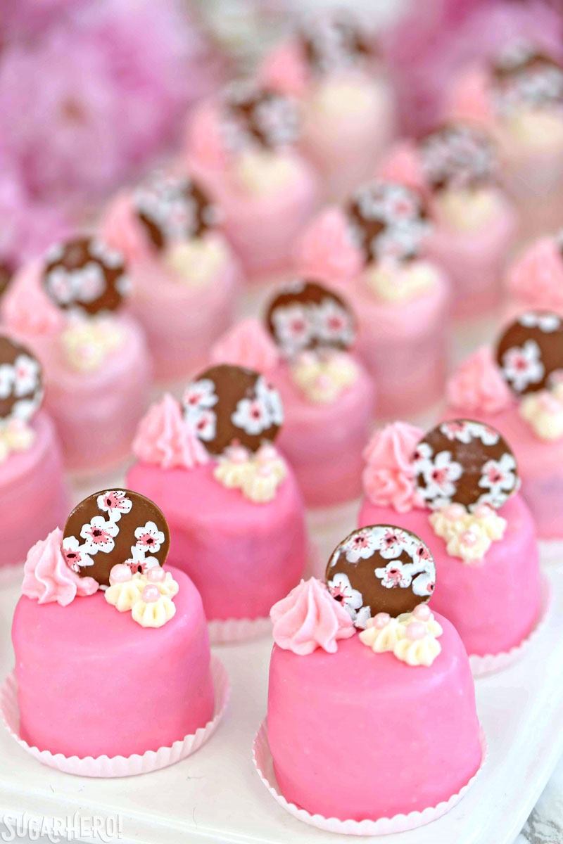 Cherry Blossom Petit Fours - cute little cake bites filled with cherry buttercream and jam! | From SugarHero.com Cherry Blossom Petit Fours - cute little cake bites filled with cherry buttercream and jam! | From SugarHero.com