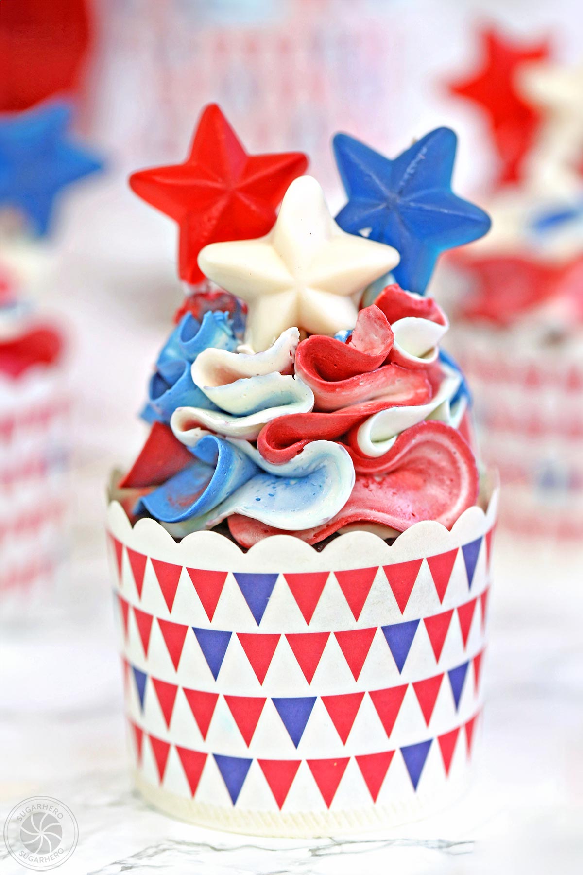 Red, White and Blue Cupcakes - pretty ruffled red velvet cupcakes, perfect for the Fourth of July! | From SugarHero.com