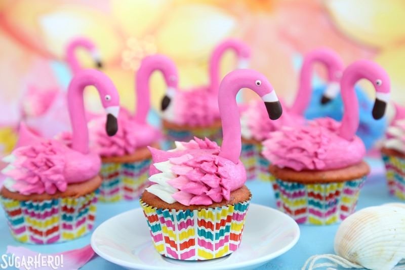 Flamingo Cupcakes - pink lemonade cupcakes decorated to look like pink flamingos! Easy, cute, and perfect for summer! Group of Pink Lemonade Flamingo Cupcakes with Fondant Flamingo Heads