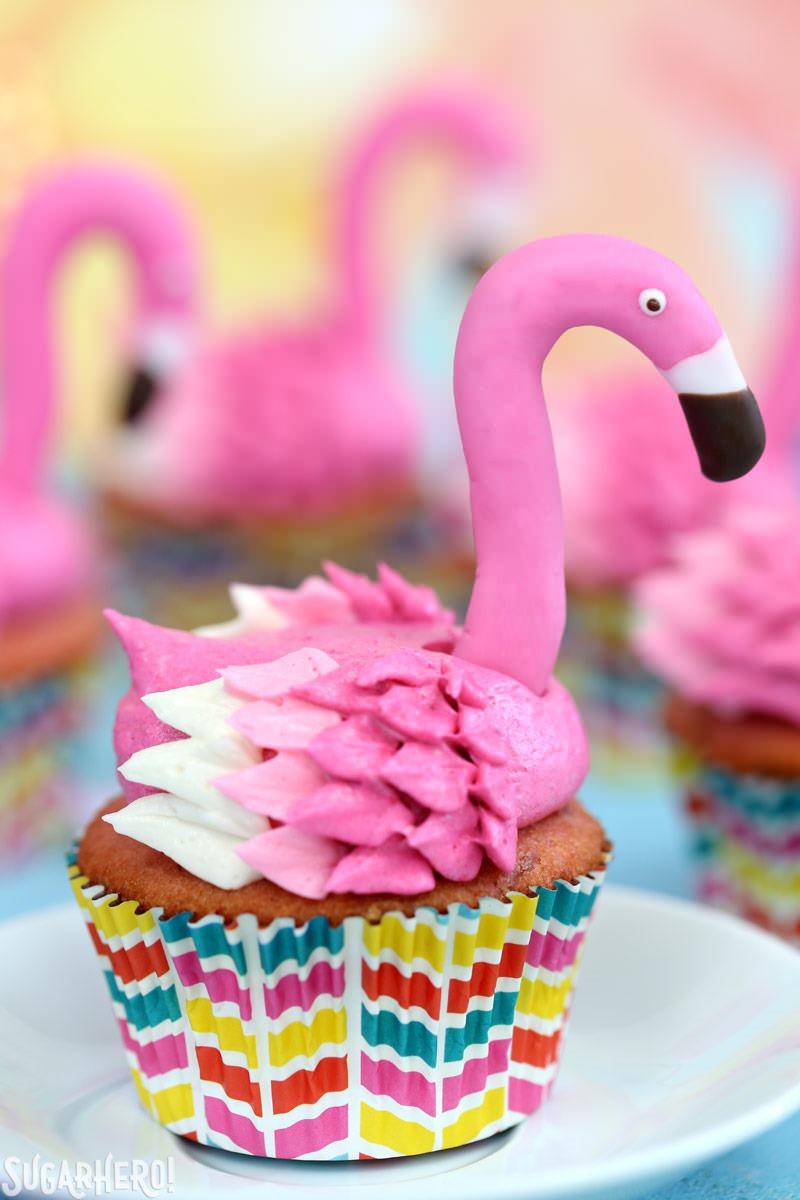 Flamingo Cupcakes - pink lemonade cupcakes decorated to look like pink flamingos! Easy, cute, and perfect for summer! | From SugarHero.com Close-Up of Pink Lemonade Flamingo Cupcake with Fondant Flamingo Head