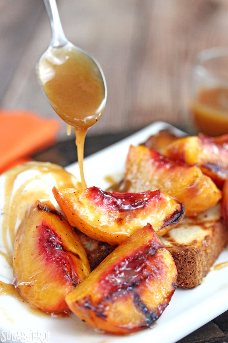 Grilled Pound Cake and Peaches - an easy summer dessert with honey-cinnamon caramel sauce! | From SugarHero.com Drizzling honey-cinnamon caramel sauce over grilled pound cake and peaches | From SugarHero.com