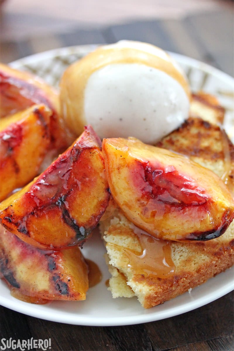 Grilled Pound Cake and Peaches - an easy summer dessert with honey-cinnamon caramel sauce! | From SugarHero.com Grilled pound cake with grilled peaches, ice cream, and honey caramel sauce | From SugarHero.com