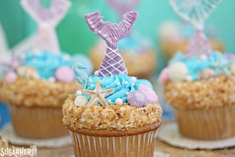 Mermaid Cupcakes - gorgeous under-the-sea cupcakes with edible mermaid tails and chocolate seashells! | From SugarHero.com Mermaid Cupcakes - close-up of mermaid cupcake with purple chocolate mermaid tail | From SugarHero.com