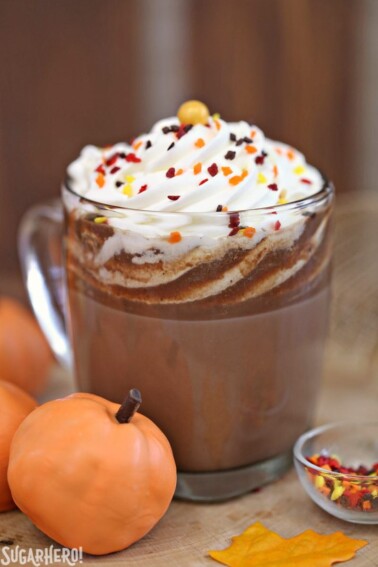 Close up of a Pumpkin Spice Hot Chocolate Truffle and a cup of hot chocolate made from the truffle.