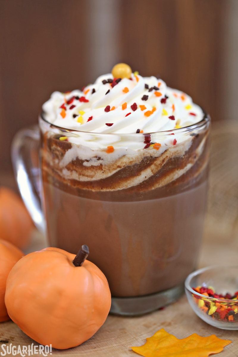 Pumpkin Spice Hot Chocolate Truffles - mug of pumpkin spice hot chocolate with pumpkin truffles next to it | From SugarHero.com