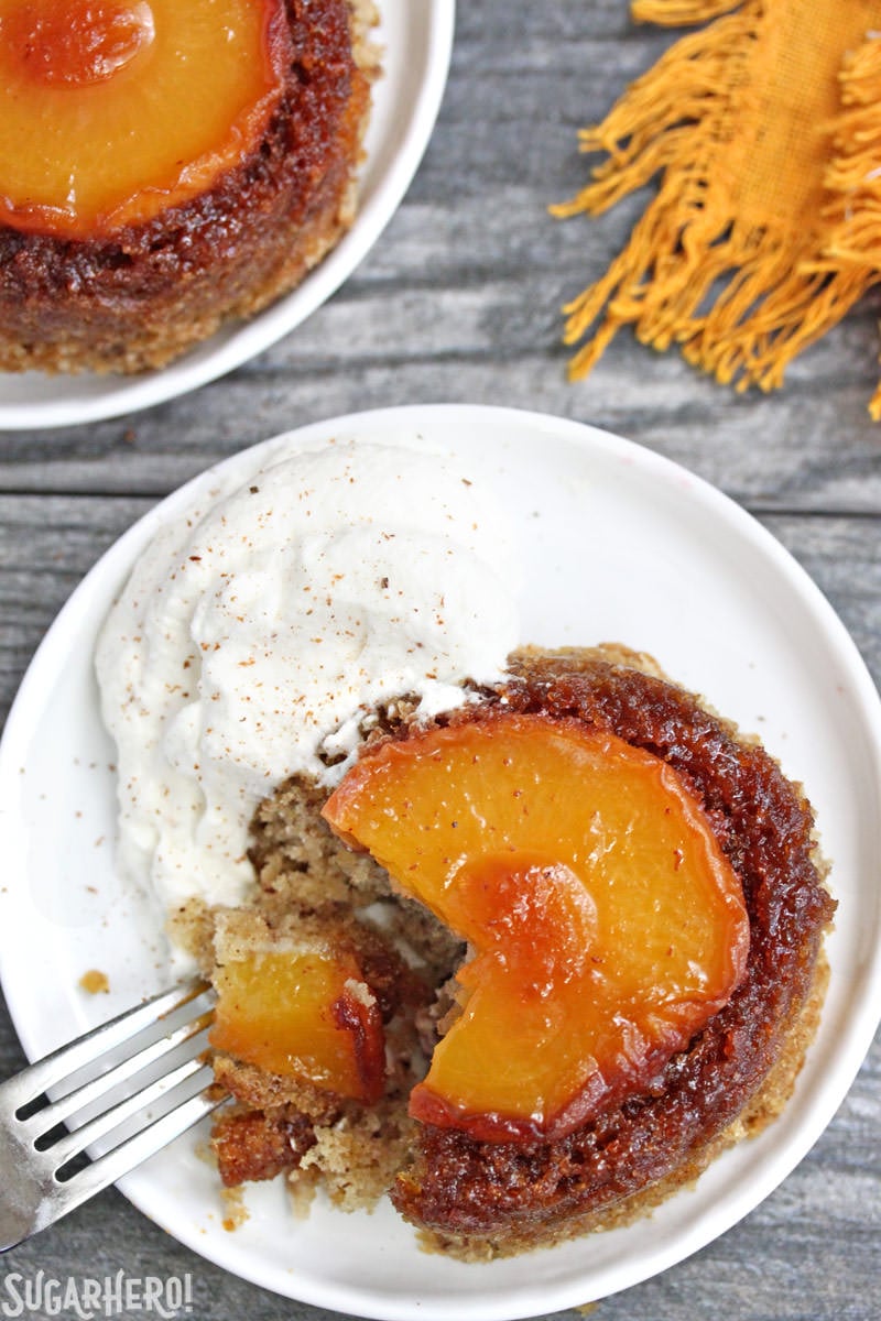 Peach Upside-Down Cakes with a bite taken out of it | From SugarHero.com