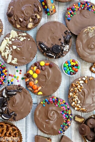 Top view of an assortment of Mega Stuffed Peanut Butter Cups with a variety of toppings.