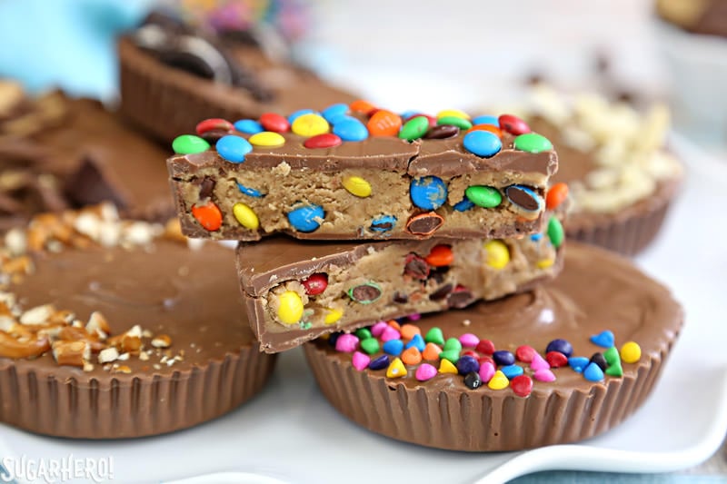 Mega Stuffed Peanut Butter Cups - jumbo homemade peanut butter cups, filled with goodies like candy, cookies, pretzels, or potato chips! | From SugarHero.com Mega Stuffed Peanut Butter Cups - close-up of peanut butter cup, cut open to show miniature M&Ms inside | From SugarHero.com