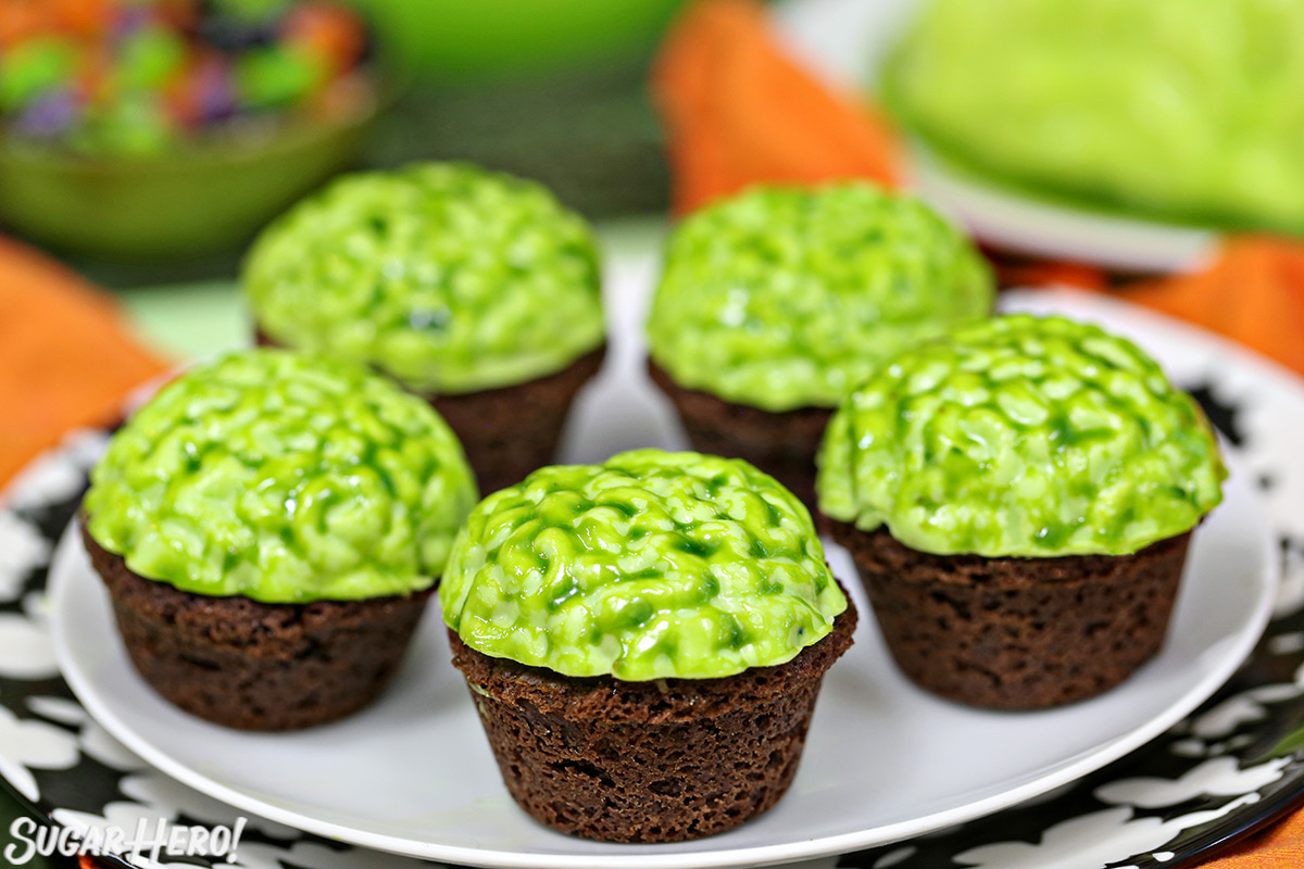 Zombie Brain Brownie Bites - with large green brain behind and caramel coffee creamer bottle | From SugarHero.com