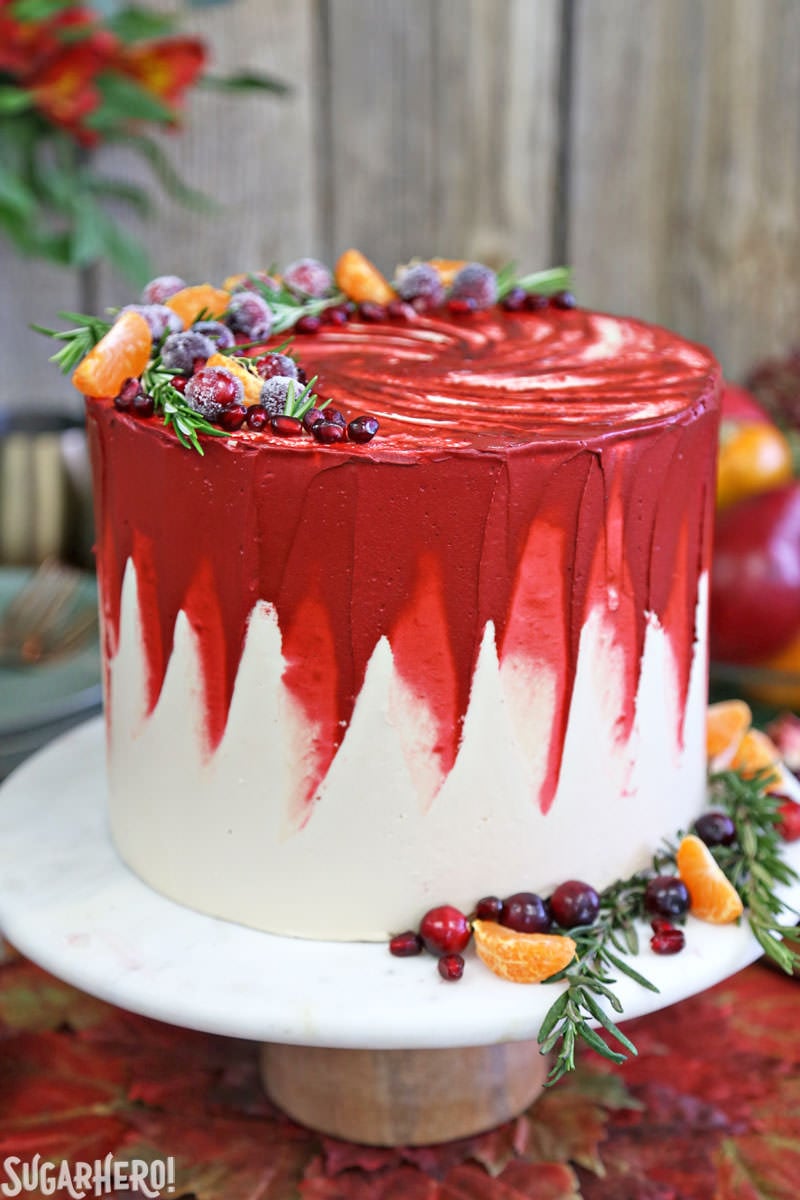 Brown Sugar Cranberry Cake - on marble cake stand decorated with fresh fruit and rosemary | From SugarHero.com
