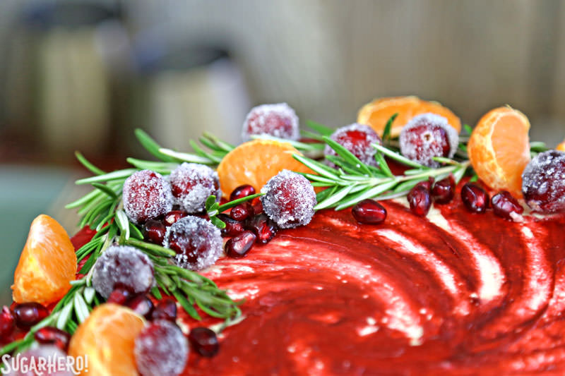 Brown Sugar Cranberry Cake - close-up of top of cake featuring fresh fruit and rosemary | From SugarHero.com