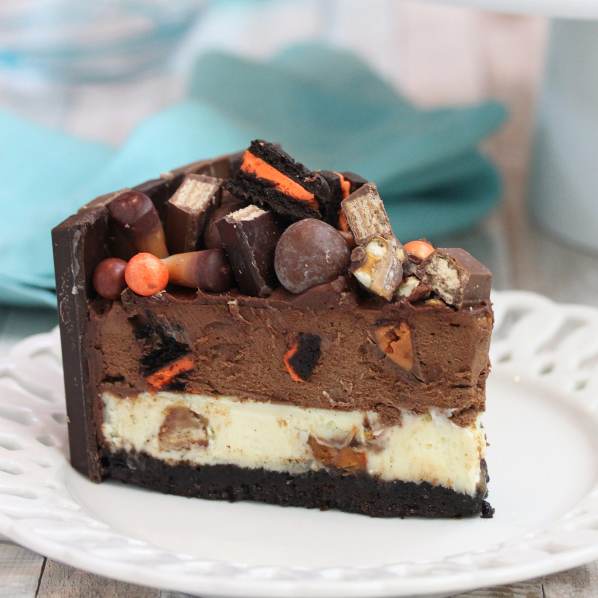 A slice of Candy Bar Cheesecake on a small white plate.