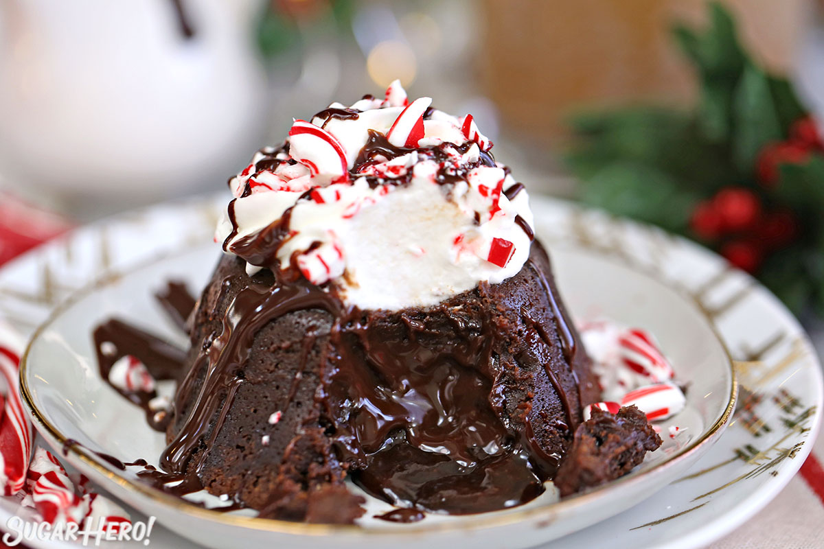 Close-up of Peppermint Lava Cake with a bite taken out of it and chocolate flowing from the center.