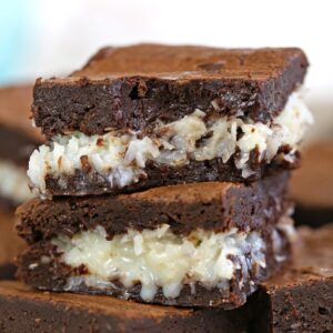 Close up of the Best Coconut Brownies cut in squares on a white plate.
