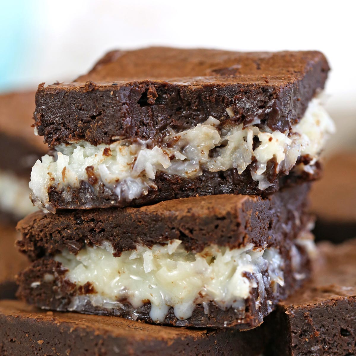 Close up of a stack of the Best Coconut Brownies cut in squares.