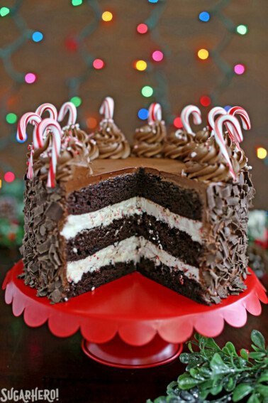Chocolate Candy Cane Cake on a red platter with slices removed to show layers.