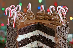 Chocolate Candy Cane Cake on a red platter with text title.