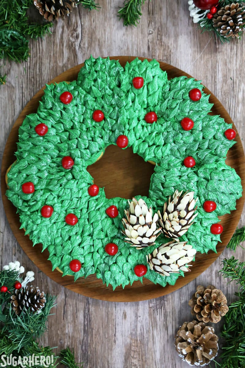 Pull-Apart Cupcake Wreath Cake - easy to make and feeds a holiday crowd! With cute edible pine cones on top. | From SugarHero.com Pull-Apart Cupcake Wreath Cake - shot of full cupcake wreath from above | From SugarHero.com