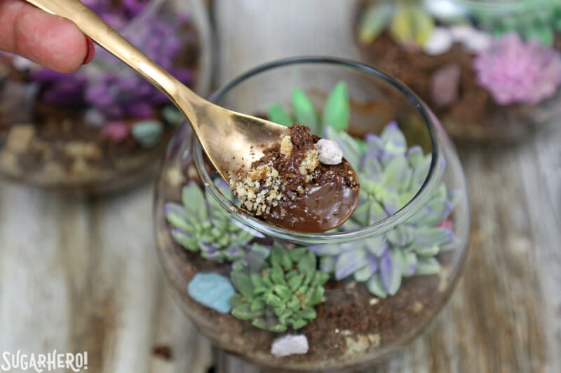 Edible Terrariums - close-up of spoon with chocolate pudding and cookie crumbs on it | From SugarHero.com