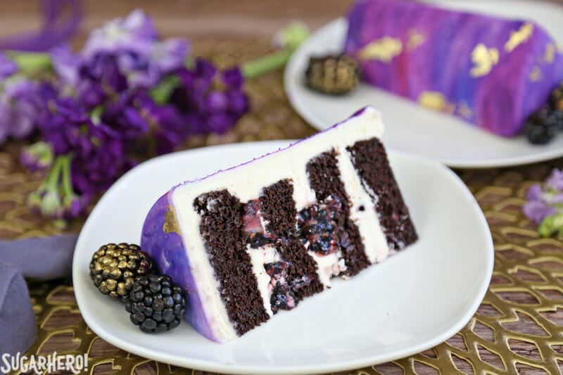 Gold Sequin Watercolor Cake - a stunning layer cake decorated with completely edible gold sequins and a gorgeous watercolor fondant effect! Perfect for parties, showers, or as a nontraditional wedding cake! | From SugarHero.com Gold Sequin Watercolor Cake - close-up of one slice of cake on a plate | From SugarHero.com