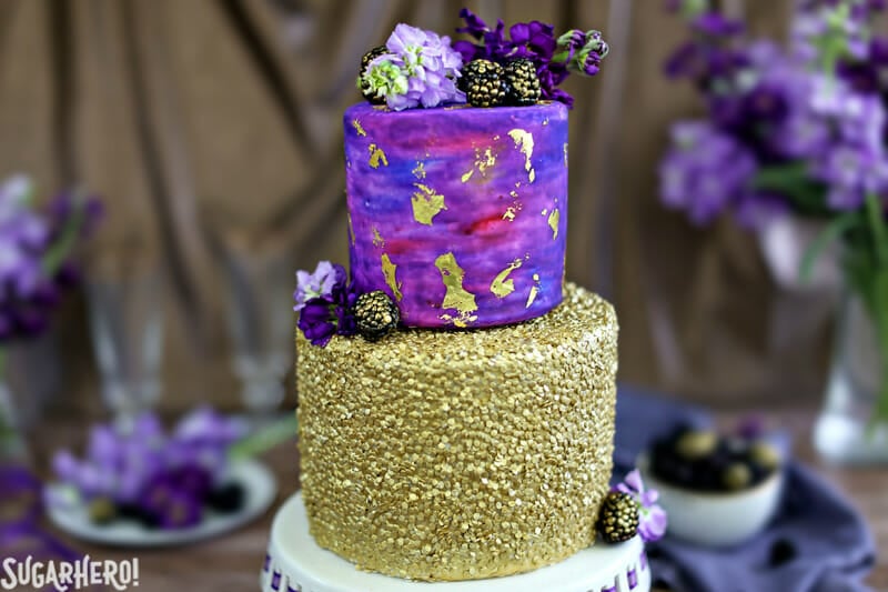 Gold Sequin Watercolor Cake - a stunning layer cake decorated with completely edible gold sequins and a gorgeous watercolor fondant effect! Perfect for parties, showers, or as a nontraditional wedding cake! | From SugarHero.com Gold Sequin Watercolor Cake | From SugarHero.com