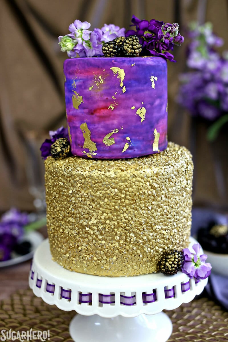 Gold Sequin Watercolor Cake on cake stand, with fresh fruit and blackberries | From SugarHero.com