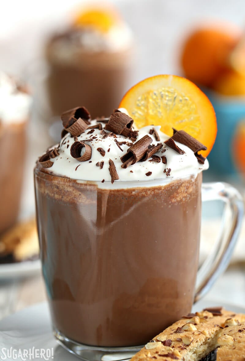 Orange Hot Chocolate with whipped cream and chocolate curls on top | From SugarHero.com