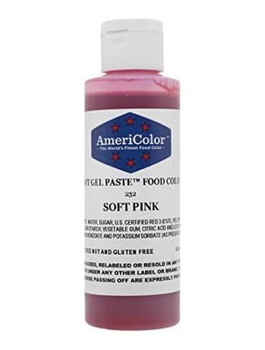 Bottle of Americolor Soft Pink gel food coloring on a white background.