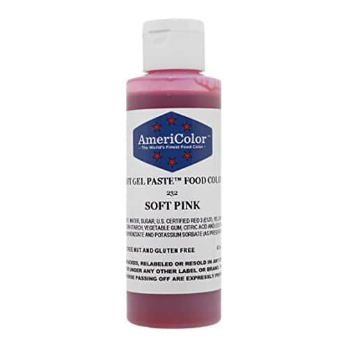 Bottle of Americolor Soft Pink gel food coloring on a white background.