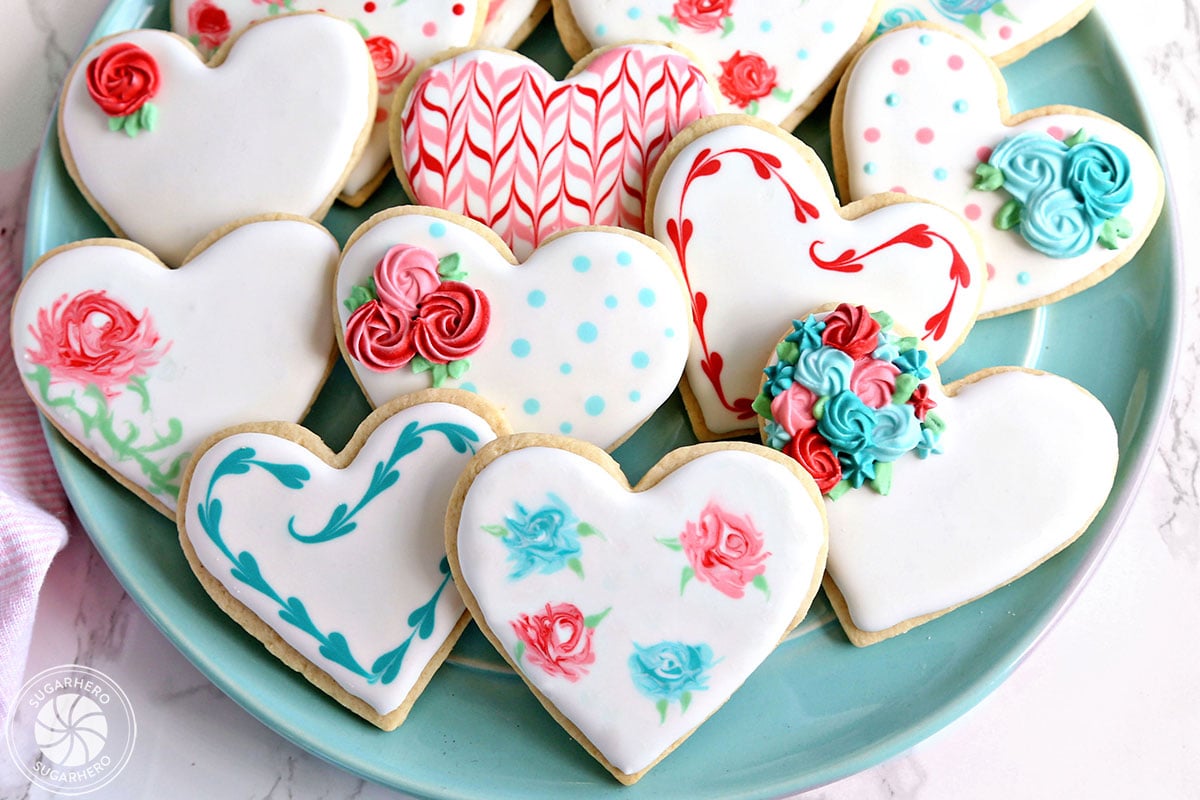 Valentine's Day Sugar Cookies - a platter of assorted sugar cookies decorated for Valentine's Day | From SugarHero.com