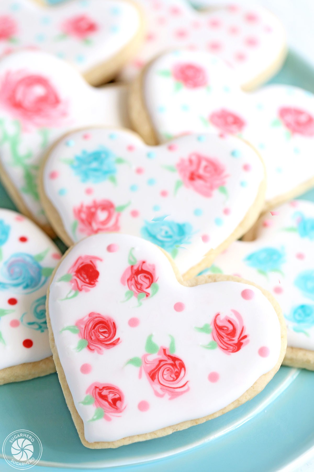 Valentine's Day Sugar Cookies - sugar cookies with an elegant rose design made out of royal icing | From SugarHero.com