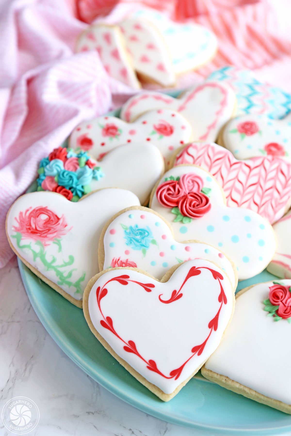 Valentine's Day Sugar Cookies - classic sugar cookies decorated with royal icing in a variety of gorgeous Valentine’s Day designs | From SugarHero.com Valentine's Day Sugar Cookies - a platter of assorted sugar cookies decorated for Valentine's Day | From SugarHero.com